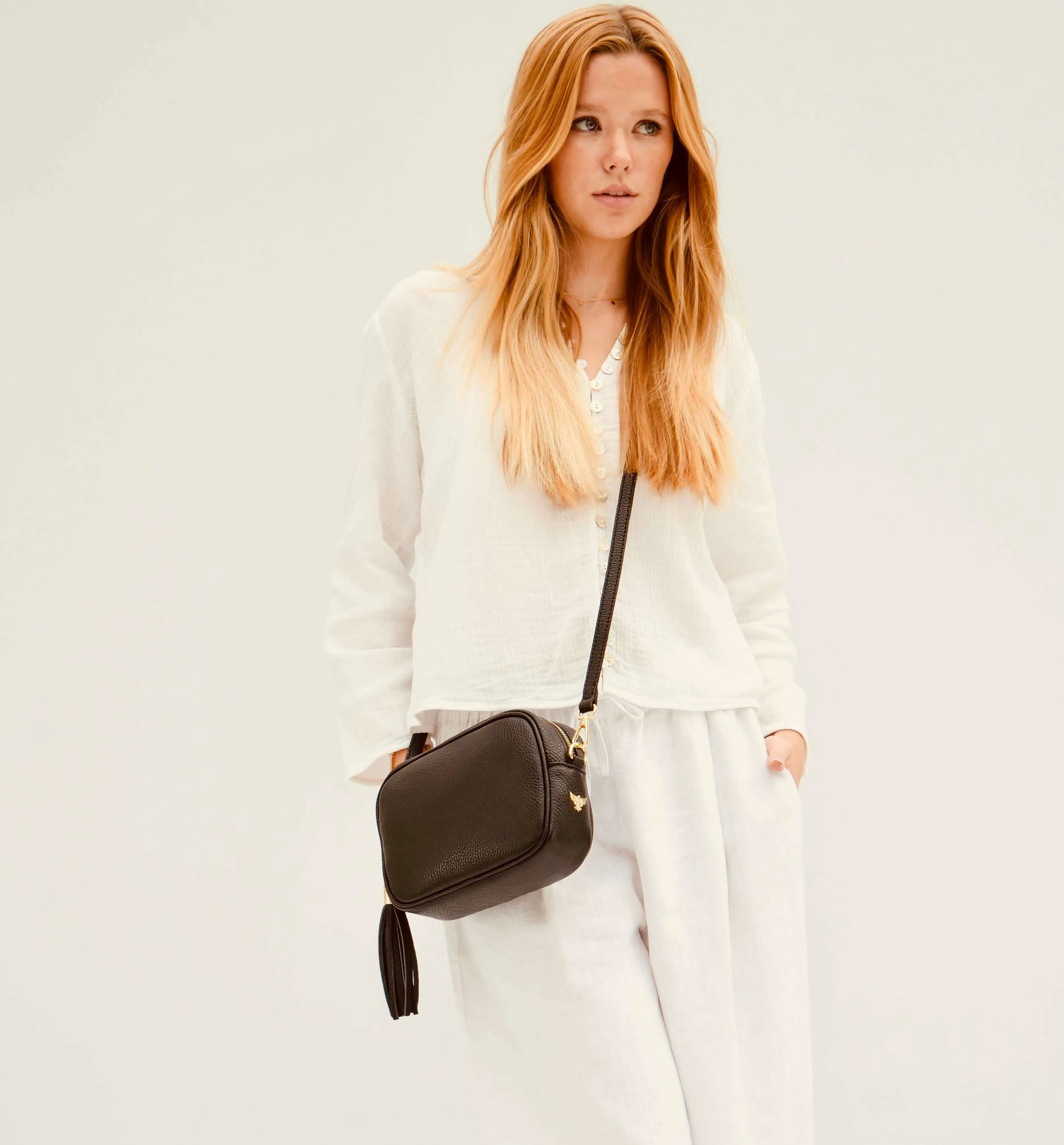 The Tassel Black Leather Crossbody Bag With Latte Stripe Strap